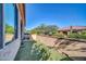 A charming, enclosed backyard space features artificial turf and a stucco wall with brick trim at 16961 W Holly St, Goodyear, AZ 85395