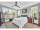 Light filled bedroom with plantation shutters, neutral paint, ceiling fan, and wood furnishings at 16961 W Holly St, Goodyear, AZ 85395