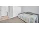 Neutral bedroom featuring comfortable bed and sliding door closet at 16961 W Holly St, Goodyear, AZ 85395