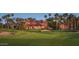 Stunning exterior view of a luxury home with manicured golf course landscaping and a tile roof at 16961 W Holly St, Goodyear, AZ 85395