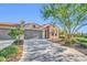 Beautiful single-story home featuring a three car garage, brick accents, and manicured landscaping at 16961 W Holly St, Goodyear, AZ 85395