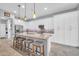 Bright kitchen featuring a center island with seating, white cabinets, and stainless steel appliances at 16961 W Holly St, Goodyear, AZ 85395