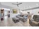 Open floor plan featuring modern ceiling fan, tile flooring, and view into the adjacent kitchen at 16961 W Holly St, Goodyear, AZ 85395