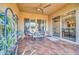 Inviting covered patio featuring stylish seating, a ceiling fan, and serene views through large windows at 16961 W Holly St, Goodyear, AZ 85395