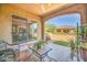 Serene covered patio with comfortable seating and views of the lush backyard and interior dining space at 16961 W Holly St, Goodyear, AZ 85395