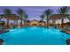 Resort-style pool area with palm trees, cabanas, and lounge chairs for ultimate relaxation at 16961 W Holly St, Goodyear, AZ 85395