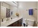 Well-lit bathroom featuring a spacious vanity with dark wood cabinets and a large mirror at 17150 N 23Rd St # 125, Phoenix, AZ 85022