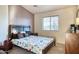 Cozy bedroom featuring a patterned comforter, neutral walls, and natural light at 17150 N 23Rd St # 125, Phoenix, AZ 85022