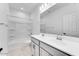 Bathroom with double sink vanity, white cabinets, and a shower-tub combination at 18153 W Hiddenview Dr, Goodyear, AZ 85338