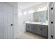 Bathroom showcasing a double sink vanity, walk-in shower, and neutral finishes at 18153 W Hiddenview Dr, Goodyear, AZ 85338