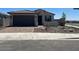 Charming single-story home features a tile roof, neutral stucco, blue shutters, and a 2-car garage at 18153 W Hiddenview Dr, Goodyear, AZ 85338