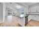 The kitchen features an island with granite countertops, stainless steel appliances, and wood floors at 18153 W Hiddenview Dr, Goodyear, AZ 85338