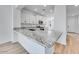 Stylish kitchen island with granite countertop, stainless sink, and bar seating, perfect for entertaining at 18153 W Hiddenview Dr, Goodyear, AZ 85338