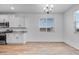 Bright kitchen showcasing granite countertops, stainless steel appliances, and white cabinetry at 18153 W Hiddenview Dr, Goodyear, AZ 85338