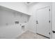 Functional laundry room with shelving and a door to the exterior at 18153 W Hiddenview Dr, Goodyear, AZ 85338