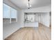 Open-concept living space with wood-look tile flooring, recessed lighting, and breakfast bar to kitchen at 18153 W Hiddenview Dr, Goodyear, AZ 85338