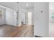 Bright living room with wood-look flooring and multiple entryways at 18153 W Hiddenview Dr, Goodyear, AZ 85338