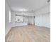 Spacious open-concept living space with wood-look tile flooring, recessed lighting, and a breakfast bar at 18153 W Hiddenview Dr, Goodyear, AZ 85338