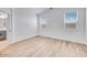 Bright main bedroom features wood-look tile flooring and ensuite bath at 18153 W Hiddenview Dr, Goodyear, AZ 85338