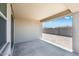 Covered patio provides space for outdoor relaxation and entertaining in this desert-landscaped backyard at 18153 W Hiddenview Dr, Goodyear, AZ 85338