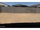 View of the empty backyard, ready for landscaping, and backyard fencing at 18248 W La Senda Dr, Surprise, AZ 85387