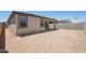 A backyard featuring a covered patio, a block fence, and a view of the neighbor's homes at 18248 W La Senda Dr, Surprise, AZ 85387