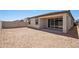 A backyard featuring a covered patio area with a block fence at 18248 W La Senda Dr, Surprise, AZ 85387