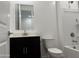 Bathroom featuring a modern vanity, toilet, and a shower-tub combination with white tile surround at 18248 W La Senda Dr, Surprise, AZ 85387
