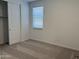 Cozy bedroom featuring carpet flooring and a window for natural light at 18248 W La Senda Dr, Surprise, AZ 85387