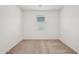 Bright bedroom with neutral carpet and a window providing natural light at 18248 W La Senda Dr, Surprise, AZ 85387