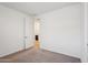 Neutral bedroom with bright walls, carpet, and an open doorway at 18248 W La Senda Dr, Surprise, AZ 85387