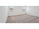 Neutral bedroom featuring wall-to-wall carpet and bright windows at 18248 W La Senda Dr, Surprise, AZ 85387