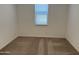 Bedroom showcasing neutral carpet and a window with blinds for soft, natural light at 18248 W La Senda Dr, Surprise, AZ 85387