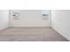 Neutral bedroom featuring wall-to-wall carpet and bright windows at 18248 W La Senda Dr, Surprise, AZ 85387