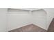 Carpeted walk-in closet featuring white walls, neutral-colored carpet, and shelving and clothing rods at 18248 W La Senda Dr, Surprise, AZ 85387