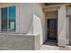 Close up of the front door and entry way, showing exterior materials and door design at 18248 W La Senda Dr, Surprise, AZ 85387