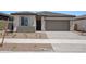Charming single-story home featuring a two-car garage and low maintenance desert landscaping at 18248 W La Senda Dr, Surprise, AZ 85387