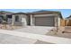 Charming single-story home featuring a two-car garage and low maintenance desert landscaping at 18248 W La Senda Dr, Surprise, AZ 85387