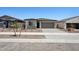Charming single-story home featuring a two-car garage and low maintenance desert landscaping at 18248 W La Senda Dr, Surprise, AZ 85387