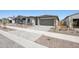 Charming single-story home featuring a two-car garage and low maintenance desert landscaping at 18248 W La Senda Dr, Surprise, AZ 85387