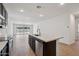 Modern kitchen features an island with a sink and stainless steel appliances at 18248 W La Senda Dr, Surprise, AZ 85387