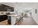 Open-concept kitchen featuring a kitchen island with seating and stainless steel appliances at 18248 W La Senda Dr, Surprise, AZ 85387