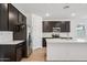 Dark wood cabinets and stainless steel appliances create a modern look in this kitchen at 18248 W La Senda Dr, Surprise, AZ 85387