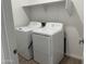 Convenient laundry room with washer, dryer and a storage shelf at 18248 W La Senda Dr, Surprise, AZ 85387