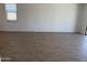 Spacious living room showcasing wood-look tile flooring and natural light at 18248 W La Senda Dr, Surprise, AZ 85387