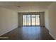 Spacious living room with tile flooring and sliding glass doors leading to the backyard at 18248 W La Senda Dr, Surprise, AZ 85387