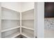 Walk-in pantry featuring ample shelving and easy access to the kitchen at 18248 W La Senda Dr, Surprise, AZ 85387