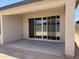 View of the covered patio leading to an empty backyard at 18248 W La Senda Dr, Surprise, AZ 85387