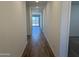 Inviting hallway boasts stylish wood-look tile flooring and recessed lighting leading to a bright living space at 18269 W Camino De Oro --, Surprise, AZ 85387