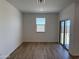 Living room offers neutral paint, wood-look floors, large window and sliding glass door to the covered patio at 18269 W Camino De Oro --, Surprise, AZ 85387